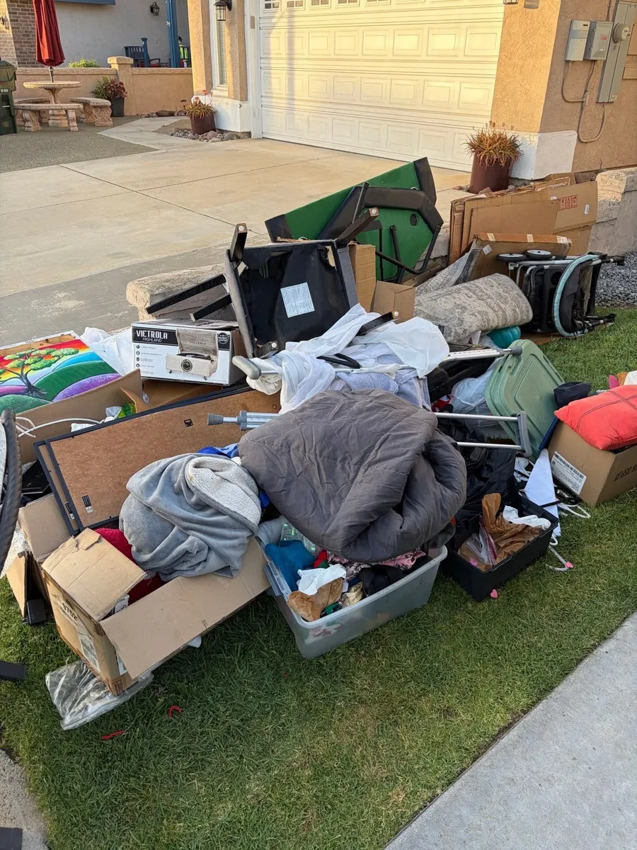 Large pile of household junk on a front lawn