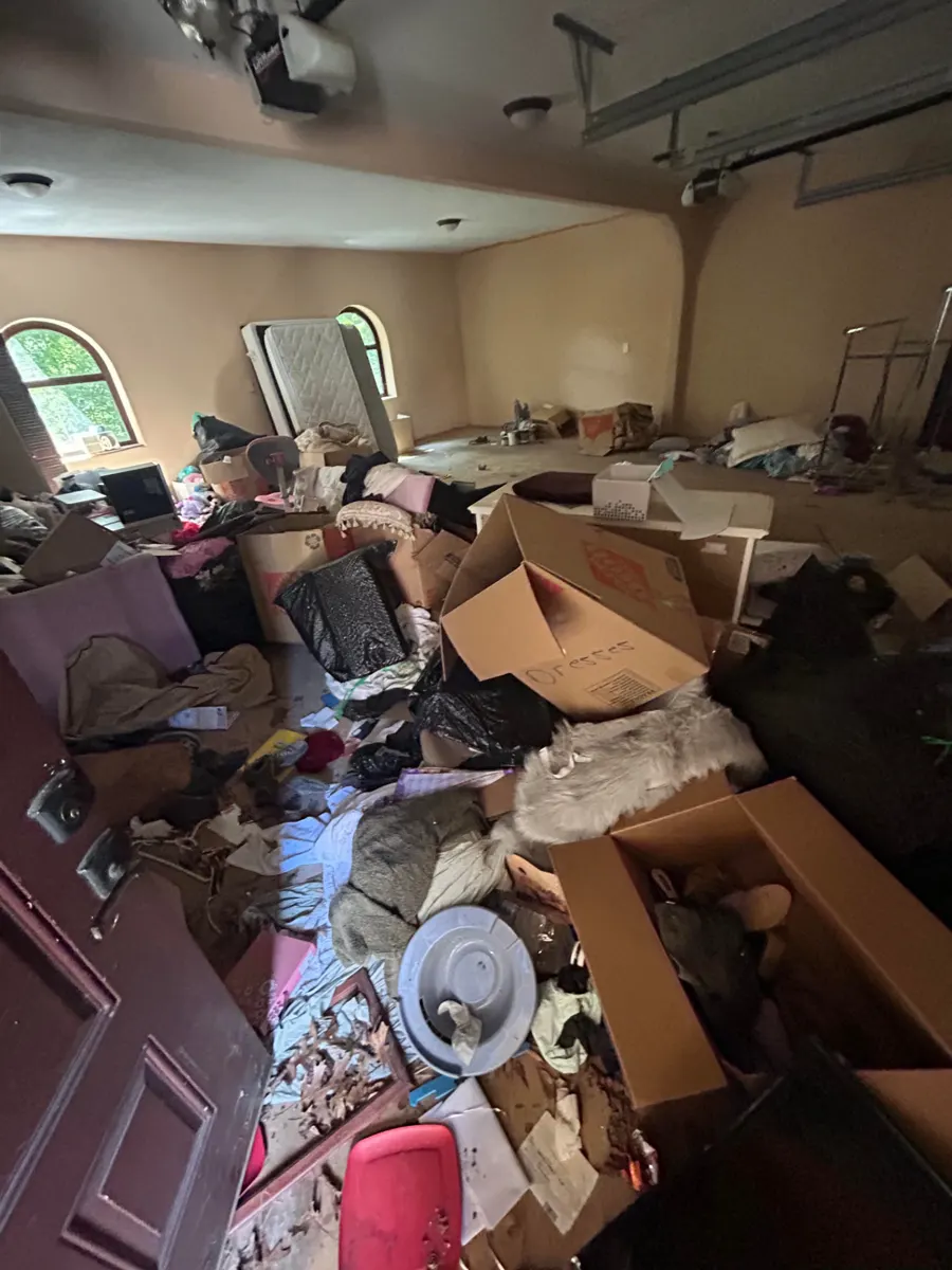 Garage packed with boxes, clothes and household items