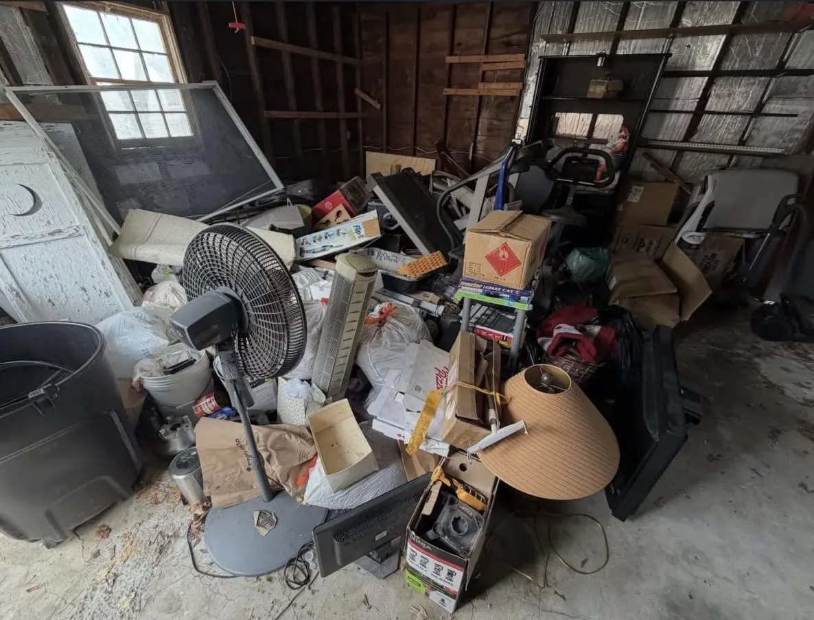 Detached garage packed with fans, boxes and equipment