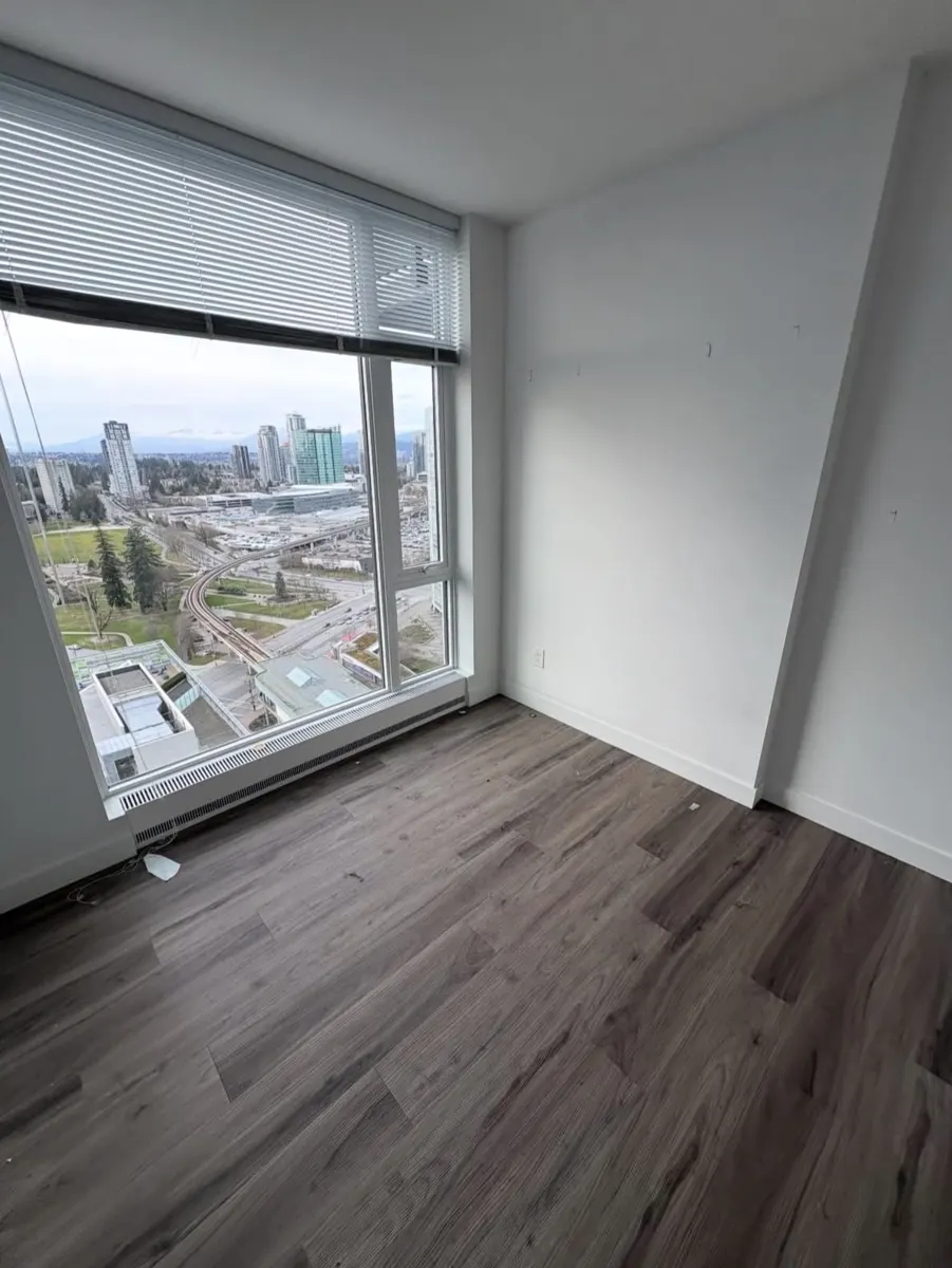 Condo bedroom with bed frame, TV and clothing before removal — after