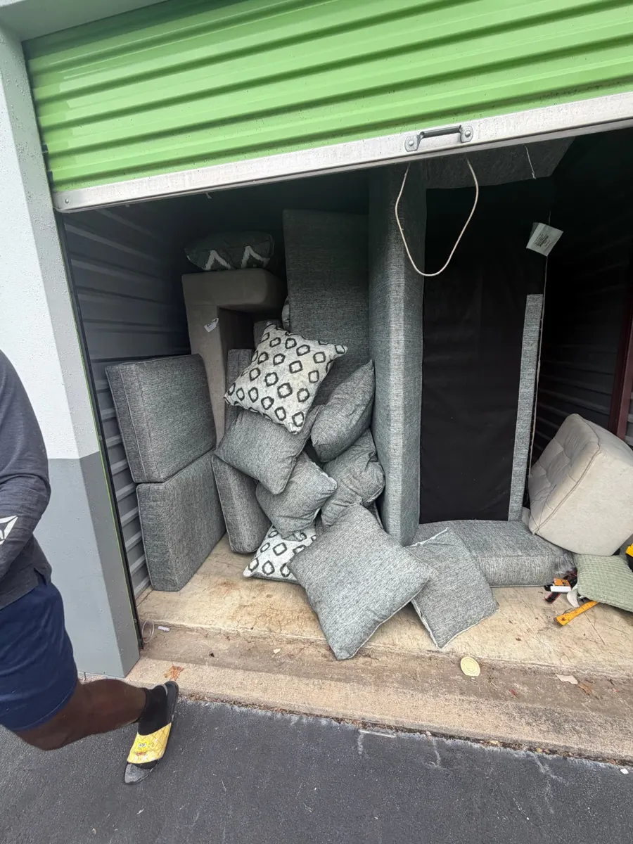 Storage unit filled with sectional sofa pieces and cushions