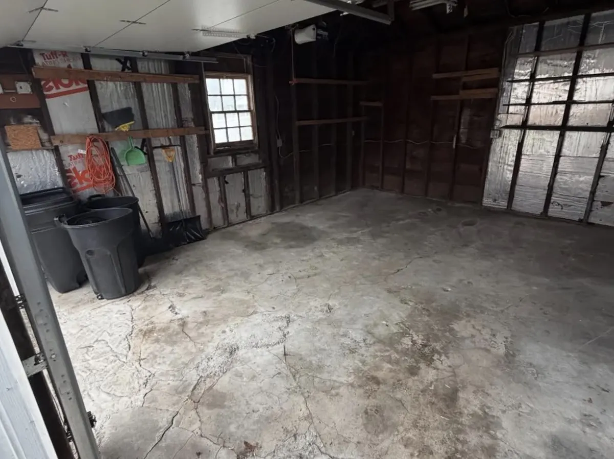 Detached garage packed with fans, boxes and equipment — after