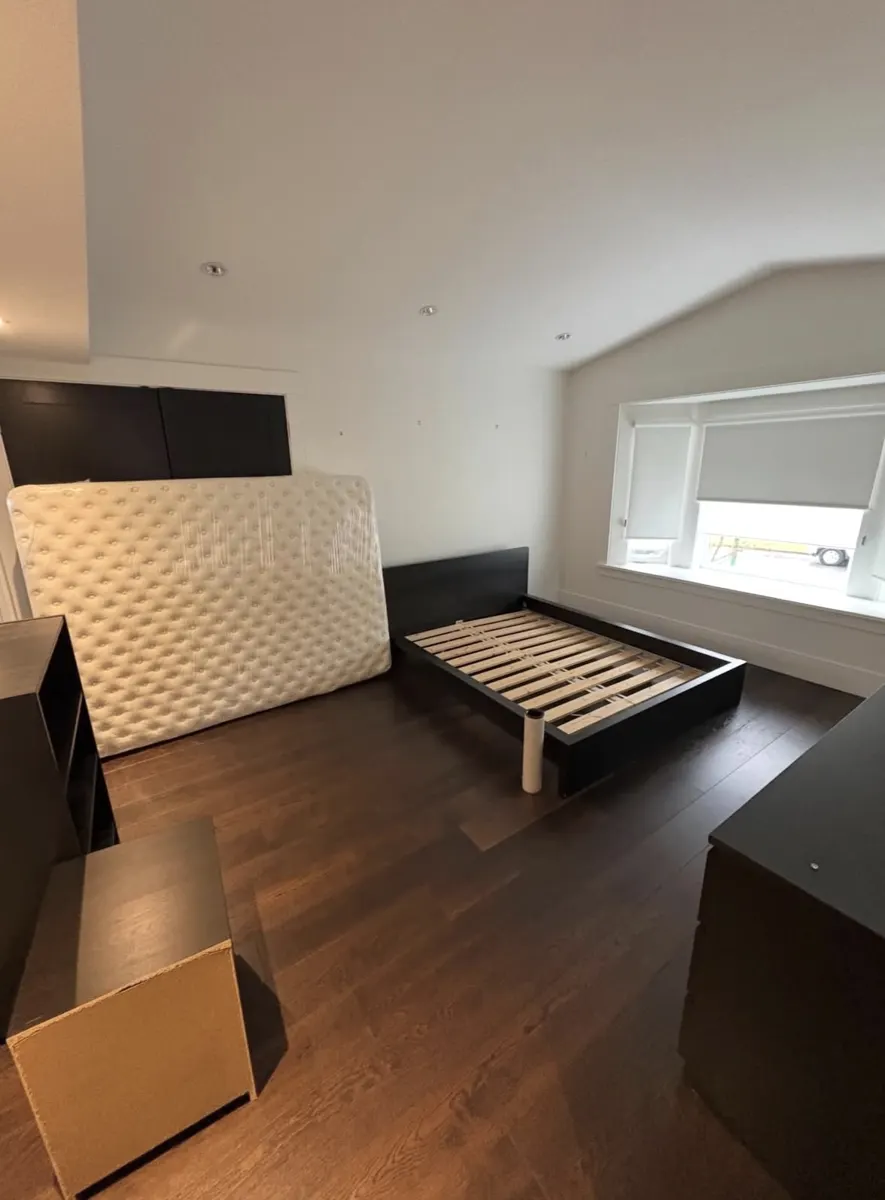 Bedroom with mattress, bed frame and dressers ready for removal
