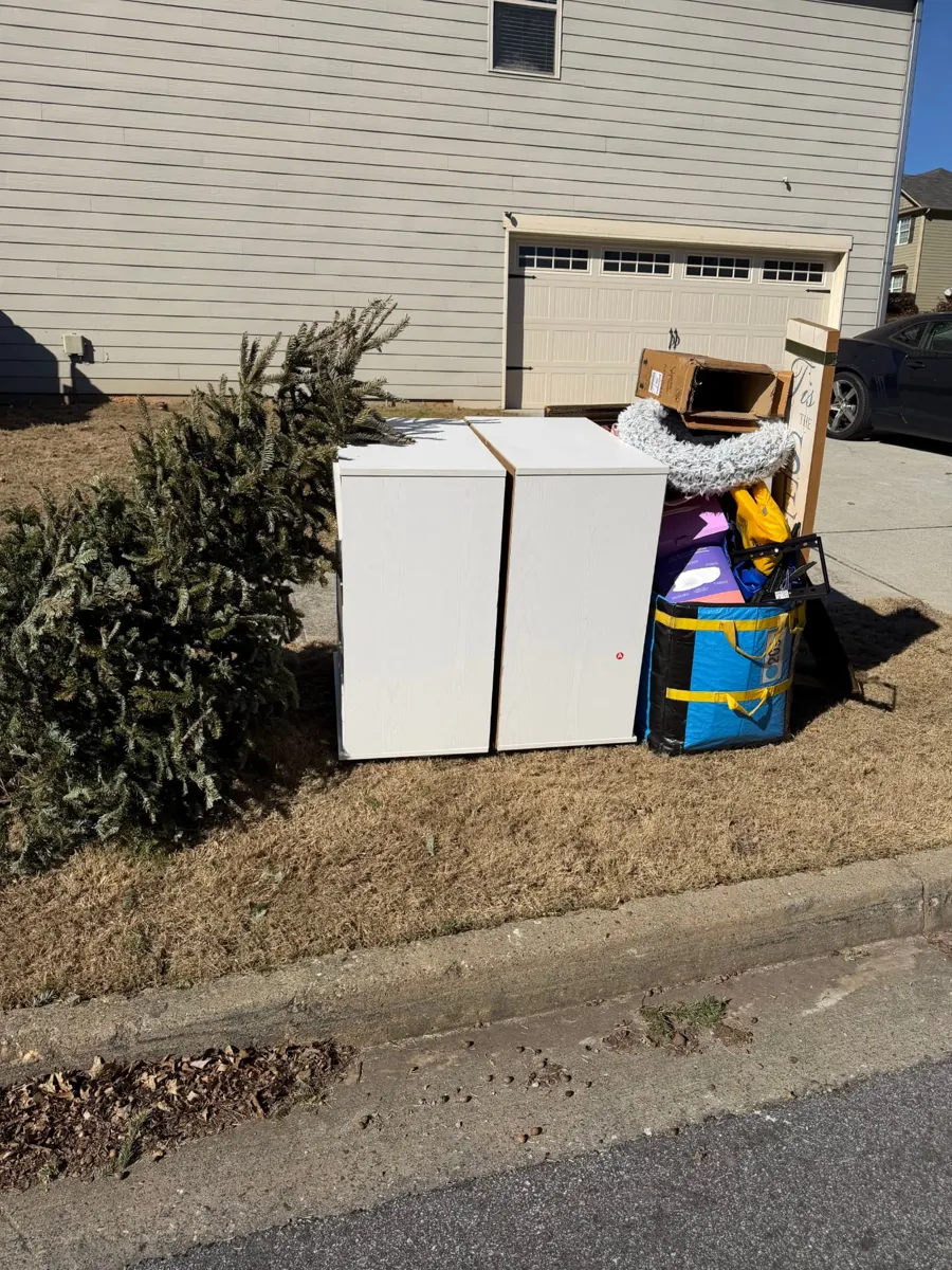 Dressers, Christmas tree and bags at the curb before pickup