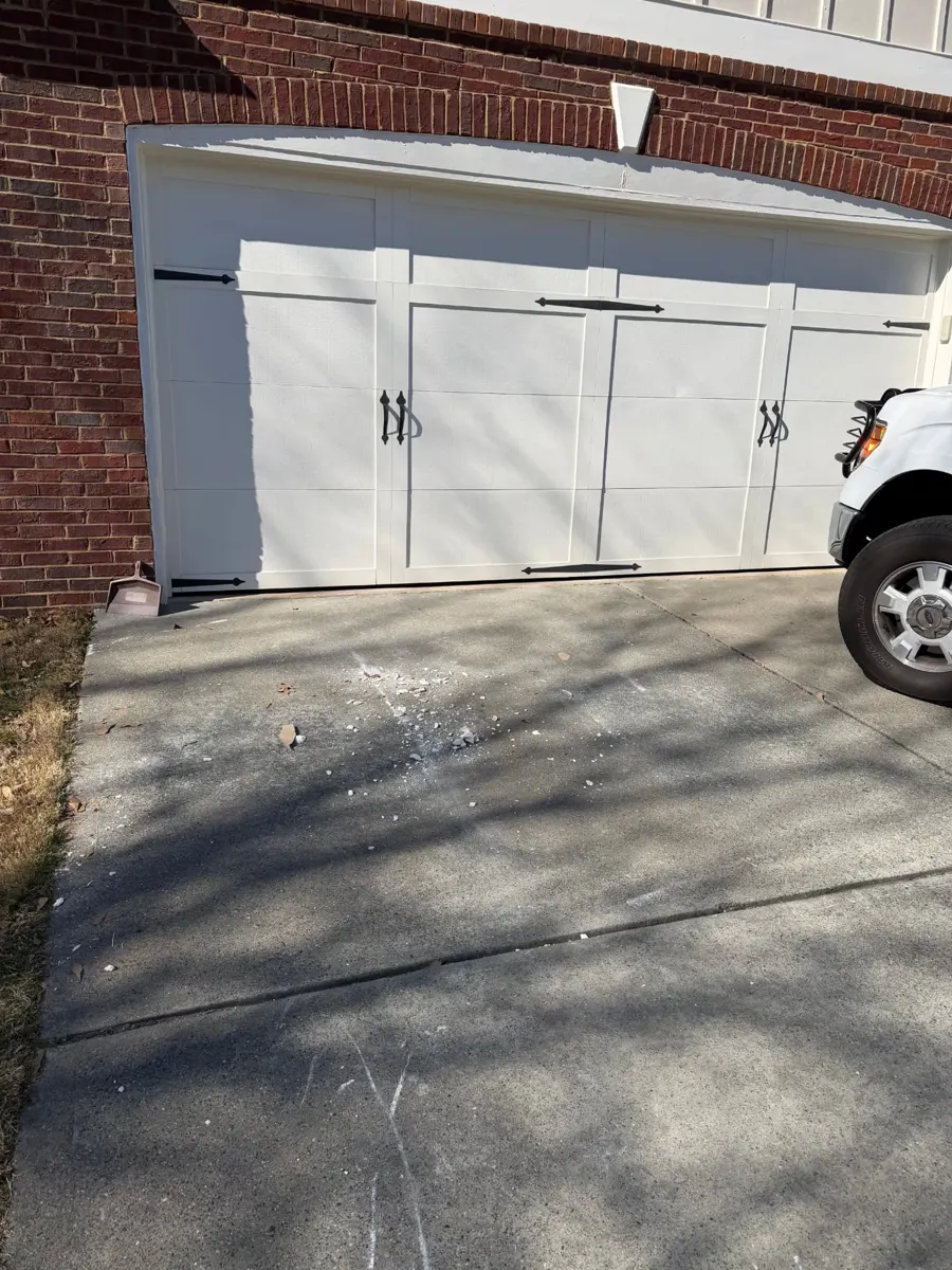 Renovation debris with lumber, trim and bags in a driveway — after