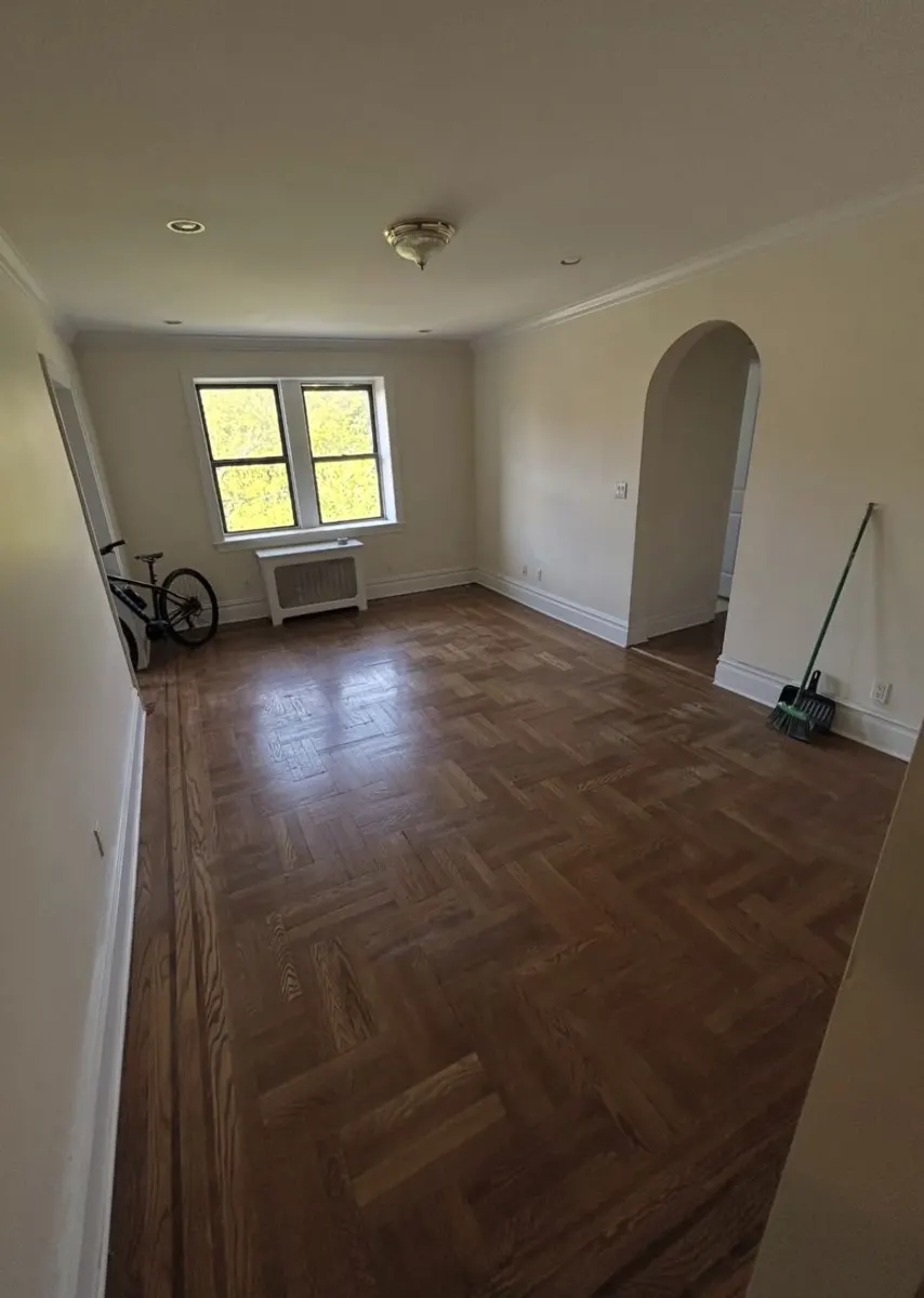 Living room with sofas, bags and air conditioners before removal — after