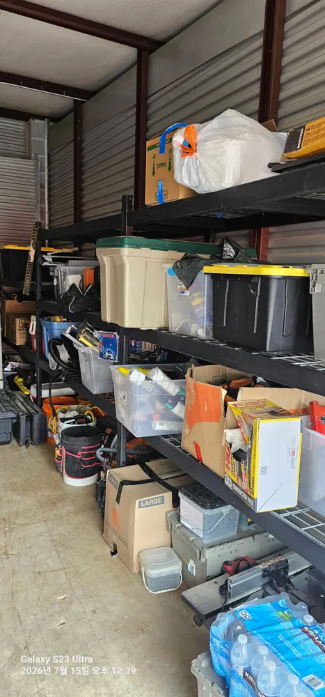 Storage unit racks with boxes and bins ready for hauling